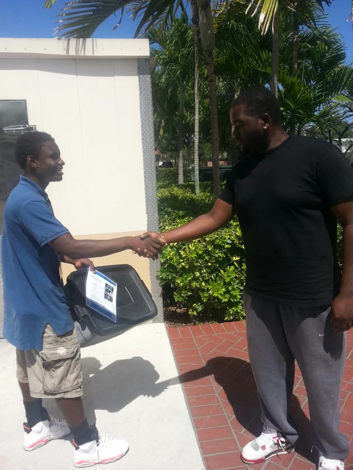 An FYM mentor and youth shaking hands