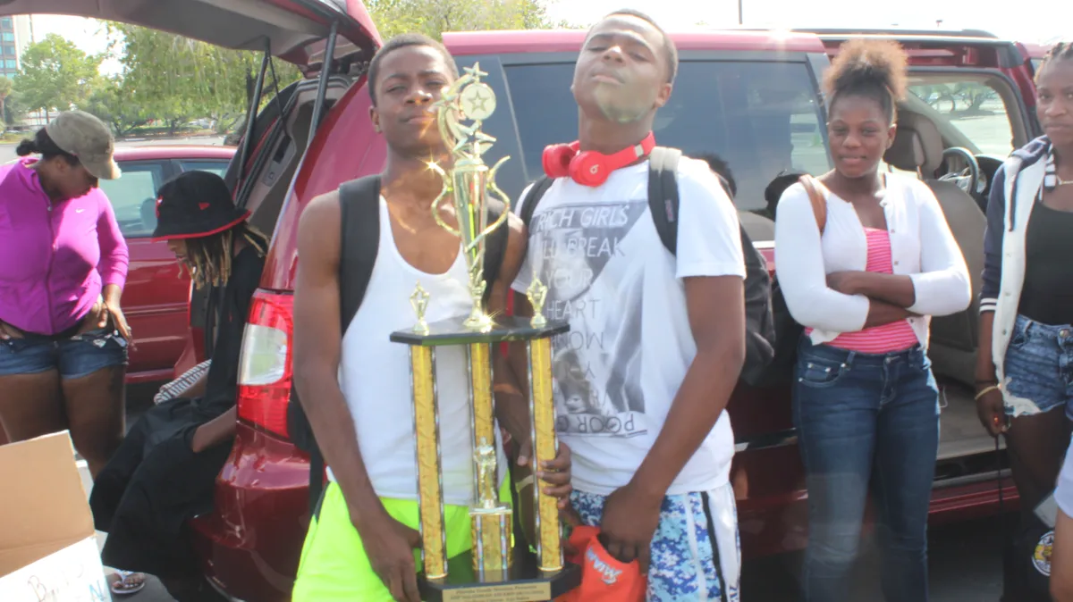 FYM athletes celebrating with championship trophies